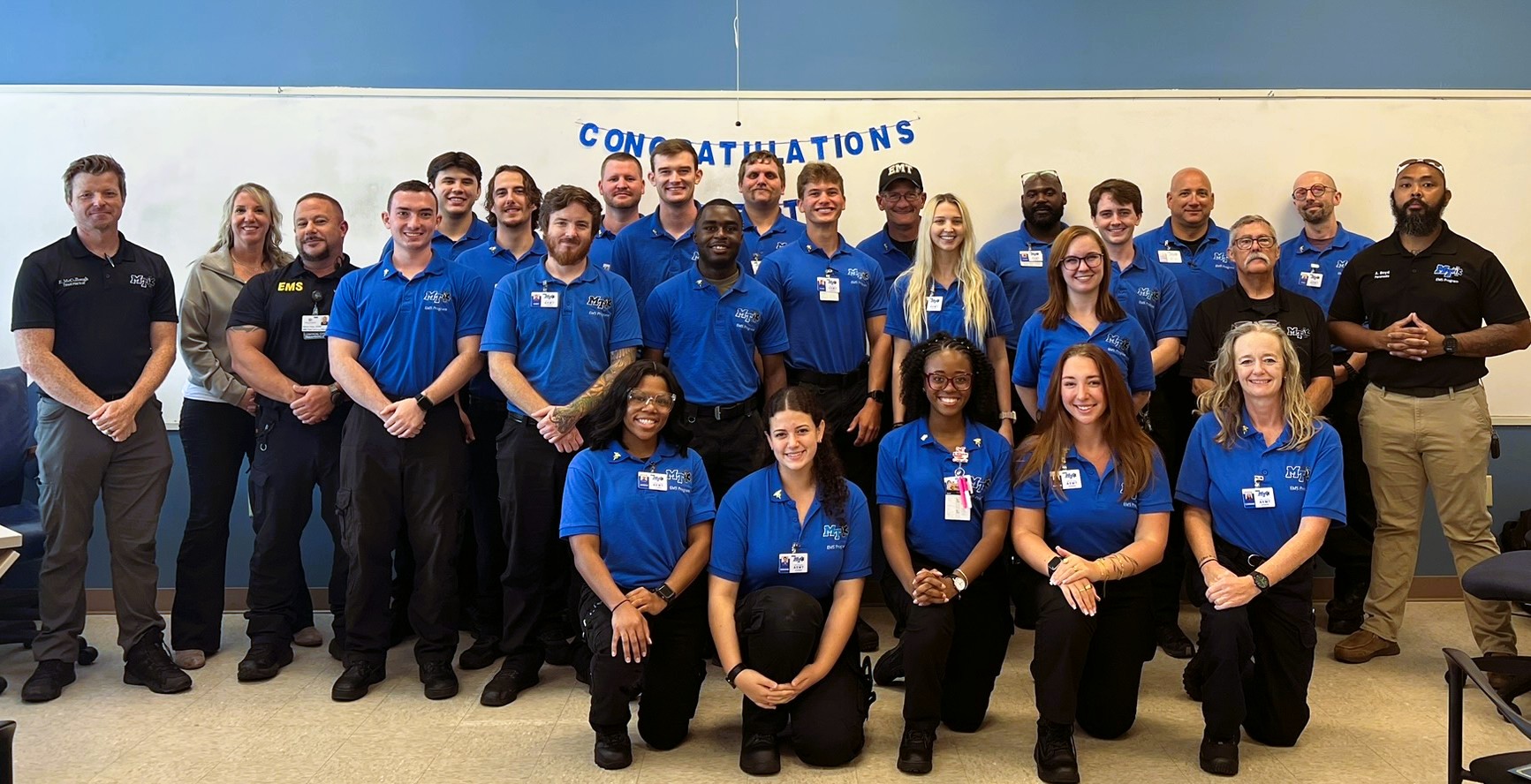 MTSU’s 2026 AEMT class poses for a group photo beneath a congratulations banner.